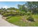 Charming single-story home with lush landscaping, mature trees, and manicured shrubs at 98 Wisteria Dr, Longwood, FL 32779