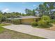 The garage is a 2-car garage with an extra wide driveway and mature shrubs at 98 Wisteria Dr, Longwood, FL 32779