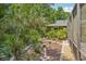 Lush garden path with tranquil scenery leading to the rear of the property at 98 Wisteria Dr, Longwood, FL 32779