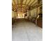 Indoor horse stalls with metal bars and open windows, running in a line into the distance, for equestrian comfort at 98 Wisteria Dr, Longwood, FL 32779