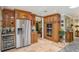 Open kitchen with stainless steel refrigerator, microwave and oven combination, and granite countertops at 98 Wisteria Dr, Longwood, FL 32779
