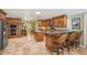 Spacious eat-in kitchen featuring custom wood cabinets, granite counters, and travertine floors at 98 Wisteria Dr, Longwood, FL 32779