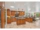 Gourmet kitchen boasts island, granite countertops, and ample cabinet space at 98 Wisteria Dr, Longwood, FL 32779
