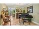 An elegant music room area with a piano and a view of the living room and home exterior at 98 Wisteria Dr, Longwood, FL 32779