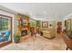 Cozy living area with a stone fireplace and comfortable seating near pool access at 98 Wisteria Dr, Longwood, FL 32779