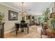 Elegant living room features a grand piano, chandelier, and sophisticated decor at 98 Wisteria Dr, Longwood, FL 32779