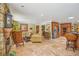 Spacious living area with stone fireplace, comfortable seating, and adjacent kitchen at 98 Wisteria Dr, Longwood, FL 32779