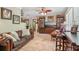 Spacious living room featuring a comfortable leather sofa, TV, and decorative bookshelves at 98 Wisteria Dr, Longwood, FL 32779