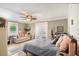 Spacious main bedroom featuring a ceiling fan, sitting area, and abundant natural light at 98 Wisteria Dr, Longwood, FL 32779