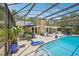 Gorgeous screened pool with lounge area and lovely views of the home's facade at 98 Wisteria Dr, Longwood, FL 32779