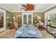Cozy sunroom features wood-paneled walls, unique ceiling fan, and inviting atmosphere at 98 Wisteria Dr, Longwood, FL 32779