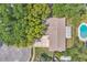 Birds eye view featuring the layout with the pool, patio, driveway and the large trees at 107 Thrush Ln, Casselberry, FL 32707