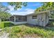 Backyard view featuring a screened patio attached to the stucco home at 107 Thrush Ln, Casselberry, FL 32707