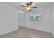 Bright bedroom featuring tile flooring, a window and a mirrored closet at 107 Thrush Ln, Casselberry, FL 32707