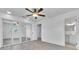 Bedroom with gray wood-look floors, a ceiling fan, closet, and attached bathroom at 107 Thrush Ln, Casselberry, FL 32707