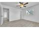 Bedroom with gray wood-look floors, a window, doorways, and a ceiling fan at 107 Thrush Ln, Casselberry, FL 32707