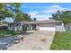 Charming single-story home with a large driveway and an attached two-car garage at 107 Thrush Ln, Casselberry, FL 32707