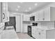 Bright kitchen features white cabinets, marble countertops, tile backsplash, and stainless steel appliances at 107 Thrush Ln, Casselberry, FL 32707