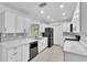 Updated kitchen with white cabinets, sleek appliances, and light marble countertops at 107 Thrush Ln, Casselberry, FL 32707