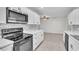 Bright kitchen featuring white cabinets, marble countertops, and stainless steel appliances at 107 Thrush Ln, Casselberry, FL 32707