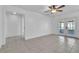 Bright living room with tiled floors, ceiling fan, and access to a screened patio at 107 Thrush Ln, Casselberry, FL 32707