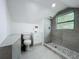Modern bathroom featuring tiled shower with pebbled floor, and sleek vanity at 1082 Hamilton Ave, Longwood, FL 32750