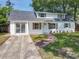 Lovely exterior view of home featuring a welcoming entrance, sliding glass door, and well-kept lawn at 1082 Hamilton Ave, Longwood, FL 32750