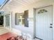 Close-up of the front entrance, highlighting the door, shutters, and the house number at 1082 Hamilton Ave, Longwood, FL 32750