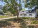 Charming two-story home with a well-maintained lawn and mature tree providing shade at 1082 Hamilton Ave, Longwood, FL 32750
