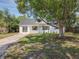 Charming two-story house with lush green lawn, a mature tree and a long driveway at 1082 Hamilton Ave, Longwood, FL 32750