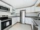 Modern kitchen with granite counters, stainless appliances, and sleek white cabinetry at 1082 Hamilton Ave, Longwood, FL 32750