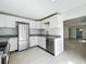 Stylish kitchen with stainless steel appliances, granite countertops, and sleek white cabinetry at 1082 Hamilton Ave, Longwood, FL 32750