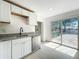Kitchen area showcasing white cabinets, granite countertops, and stainless steel appliances at 1082 Hamilton Ave, Longwood, FL 32750