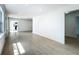 Bright, open living room features wood-look floors and neutral paint, perfect for entertaining at 1082 Hamilton Ave, Longwood, FL 32750