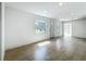 Spacious living room with natural light and wood-look floors, showcasing an open layout at 1082 Hamilton Ave, Longwood, FL 32750