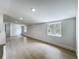 Bright, open living room features light wood floors and natural light from two windows at 1082 Hamilton Ave, Longwood, FL 32750