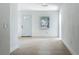 Clean living room highlighting the front door and window, providing a welcoming entry at 1082 Hamilton Ave, Longwood, FL 32750