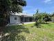 Backyard view of a house with a screened lanai and mature landscaping, providing privacy at 11725 Cuxham Dr, Orlando, FL 32837