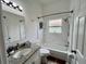 Bathroom featuring a granite vanity, toilet, and tub with shower at 11725 Cuxham Dr, Orlando, FL 32837
