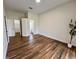 Bright bedroom featuring wood-look floors, and a plant in a white pot at 11725 Cuxham Dr, Orlando, FL 32837