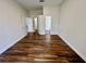 Spacious bedroom featuring wood-look flooring and neutral walls, leading to the bathroom at 11725 Cuxham Dr, Orlando, FL 32837