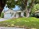 Charming single-story home with a well-manicured lawn and mature trees at 11725 Cuxham Dr, Orlando, FL 32837