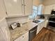A close up view of the kitchen showcasing granite countertops and stainless steel appliances at 11725 Cuxham Dr, Orlando, FL 32837