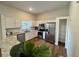 Modern kitchen features stainless steel appliances, granite countertops, and wood-look floors at 11725 Cuxham Dr, Orlando, FL 32837