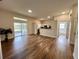 Bright living area with patio access, wood-look floors and kitchen with bar top at 11725 Cuxham Dr, Orlando, FL 32837