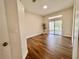 Open living room with wood-look floors and access to screened lanai at 11725 Cuxham Dr, Orlando, FL 32837