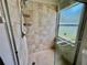 Shower stall with neutral tile and window at 11725 Cuxham Dr, Orlando, FL 32837