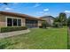 Well-maintained backyard with lush green lawn and a screened-in lanai, perfect for outdoor living at 11741 Savona Way, Orlando, FL 32827