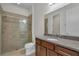 Bathroom featuring granite countertop, tile shower, and glass door at 11741 Savona Way, Orlando, FL 32827