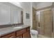 Bathroom featuring a vanity with granite countertops and a glass-enclosed shower with tiled walls at 11741 Savona Way, Orlando, FL 32827